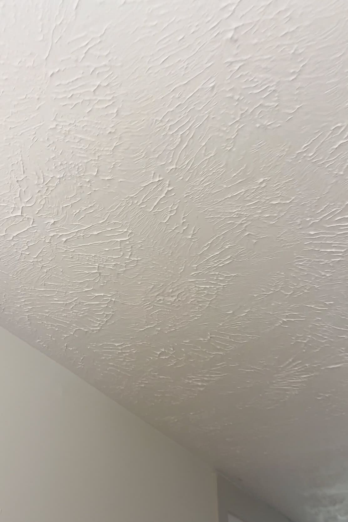 Close-up of a fully painted textured ceiling with no visible patch marks