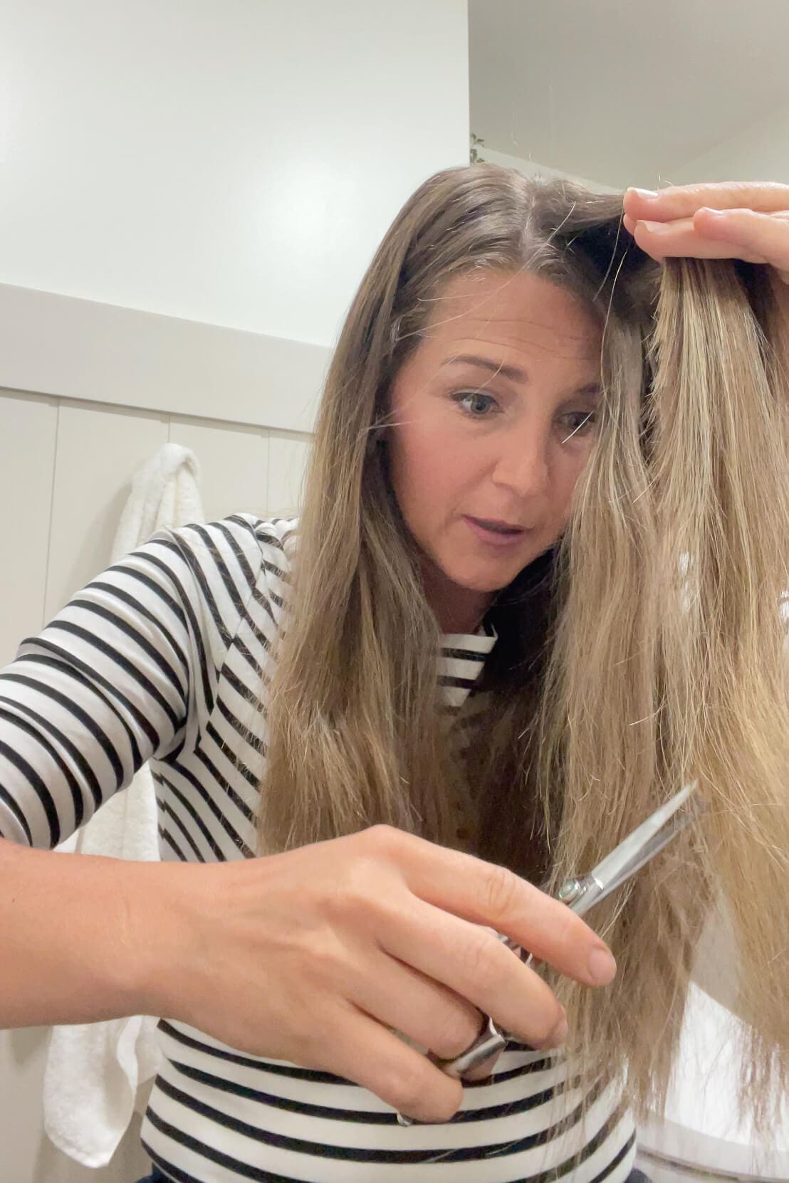 Using sharp scissors for DIY haircut.