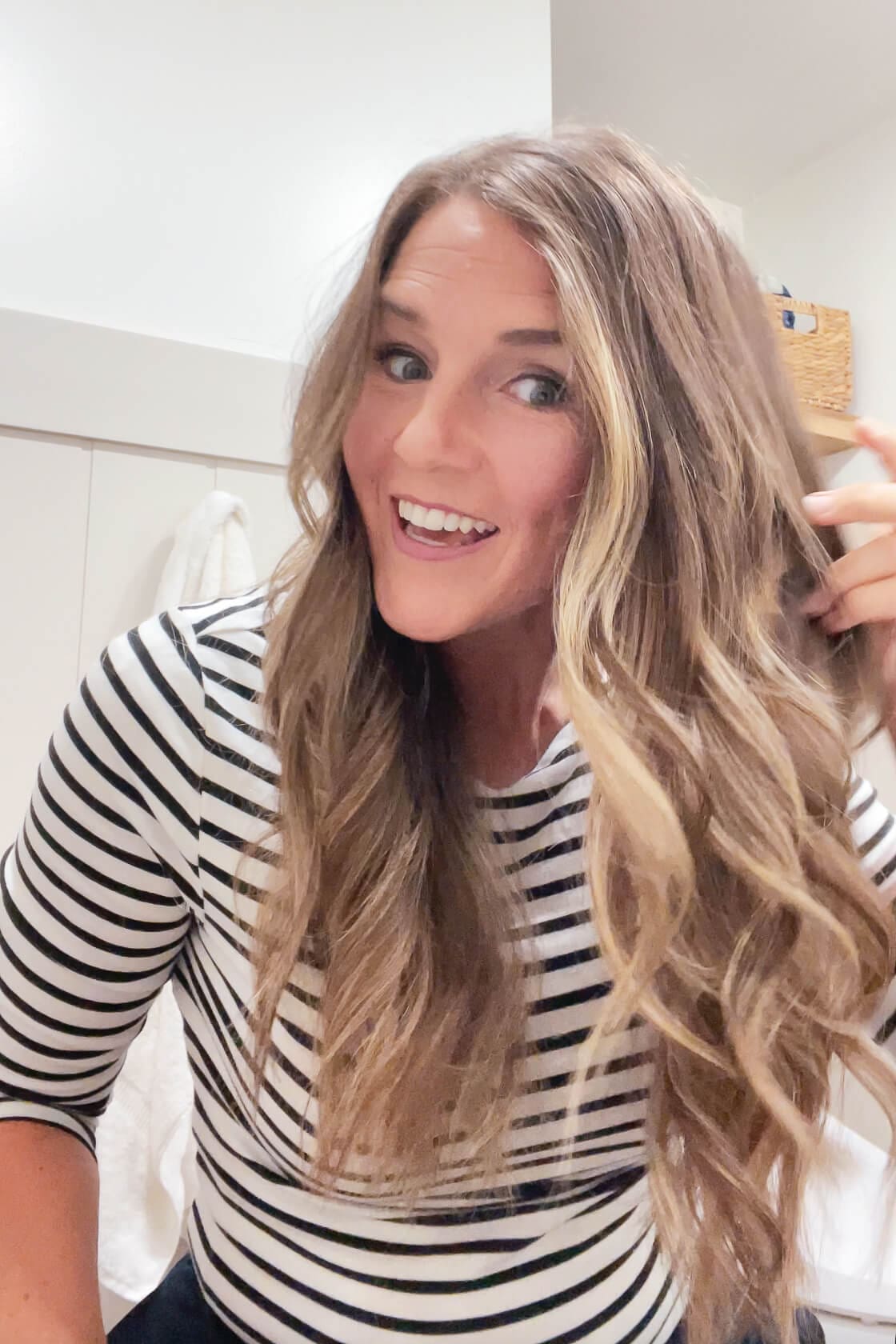 Close-up of long, curled hair showing soft layers after a DIY at-home haircut.