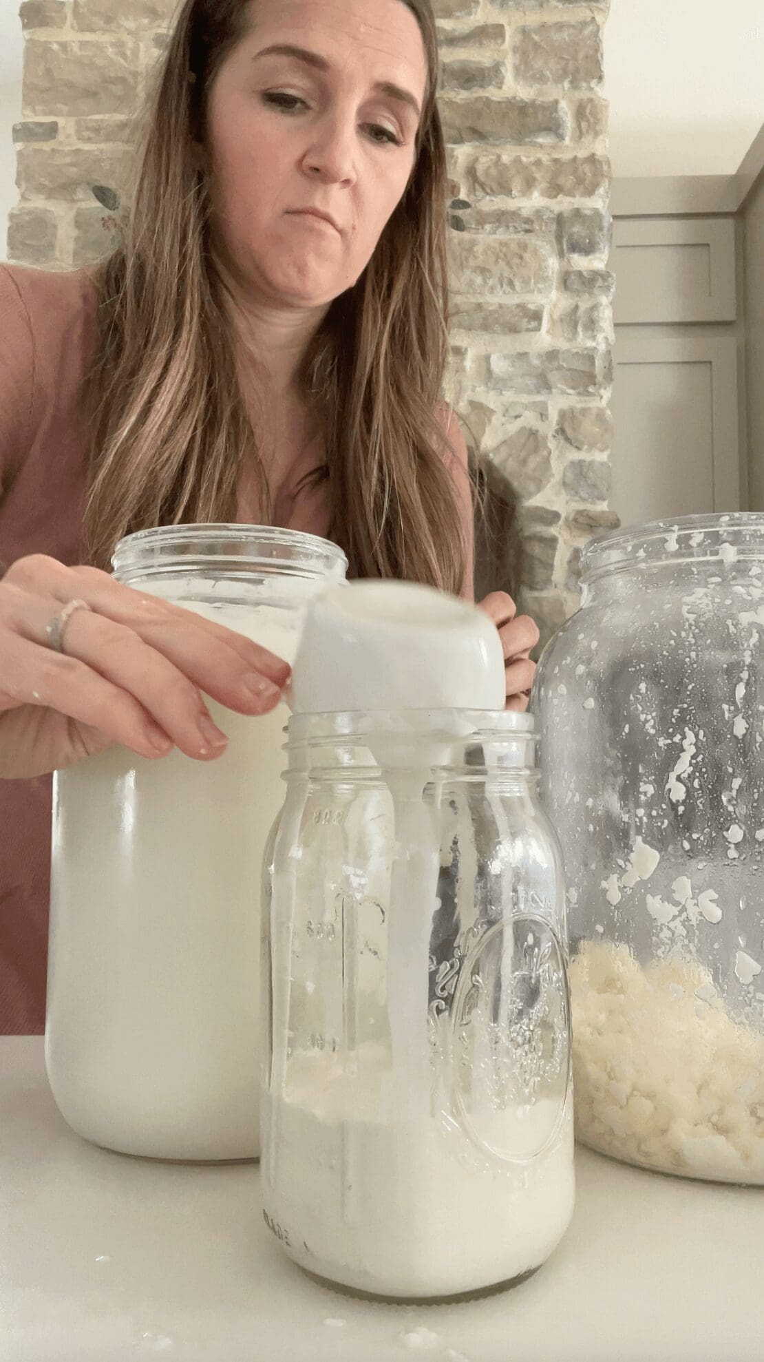 Removing cream from raw milk with a ladle.