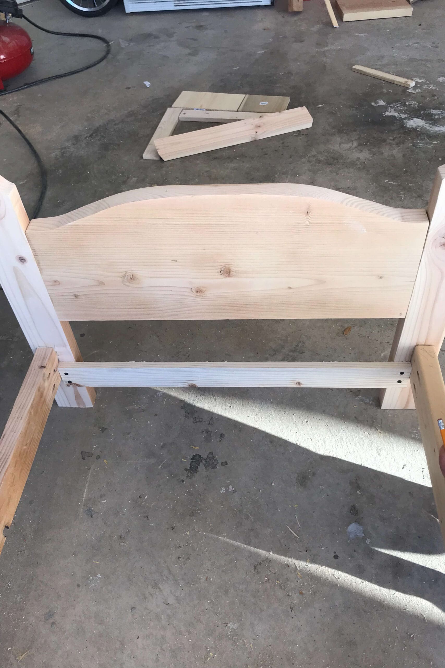 Interior view of the headboard with a center support rail added to reinforce the structure of the handmade wooden bed.
