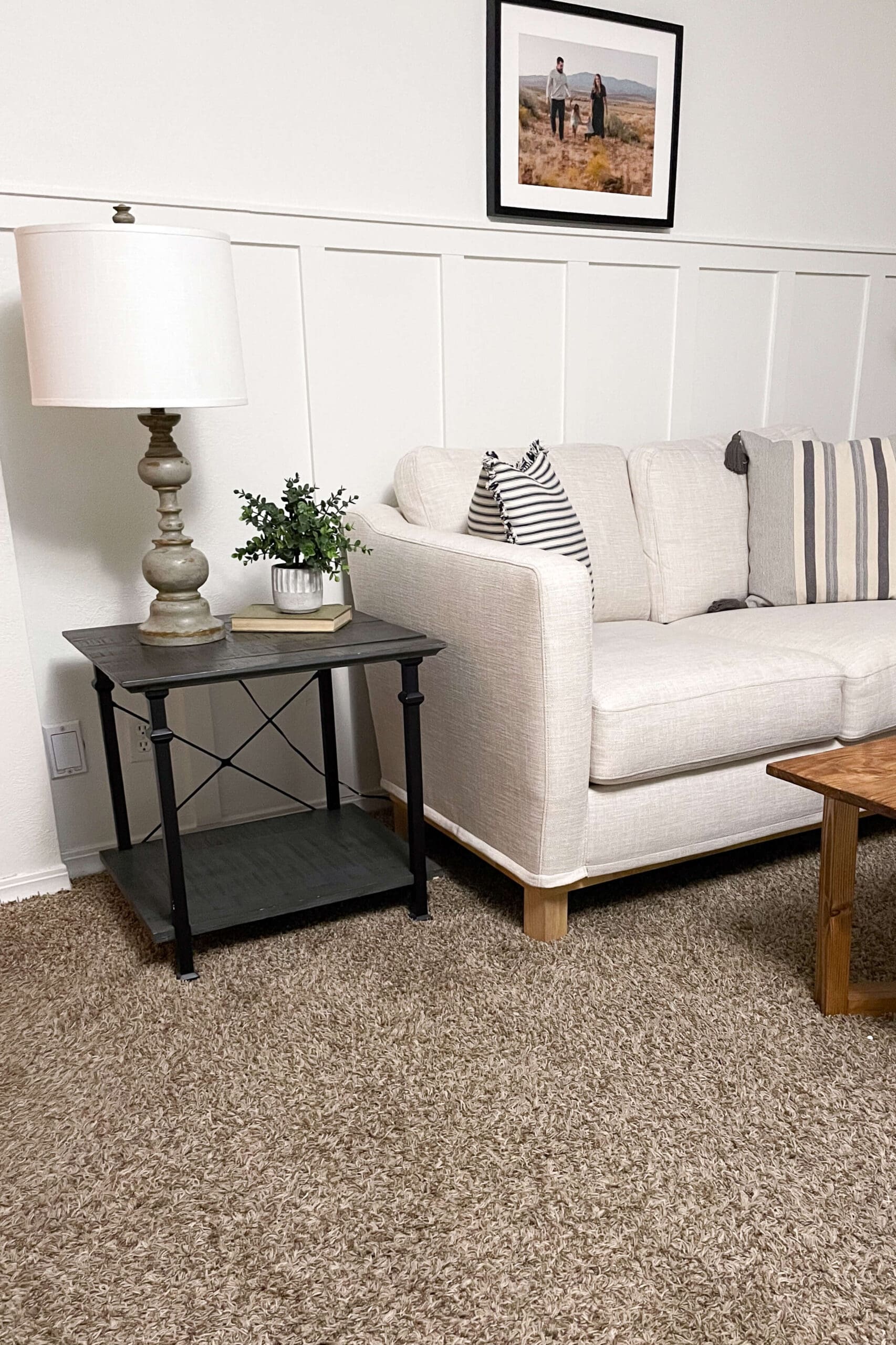 Cozy living room showcasing a simple DIY accent wall with vertical battens, paired with a farmhouse-style side table and neutral decor.
