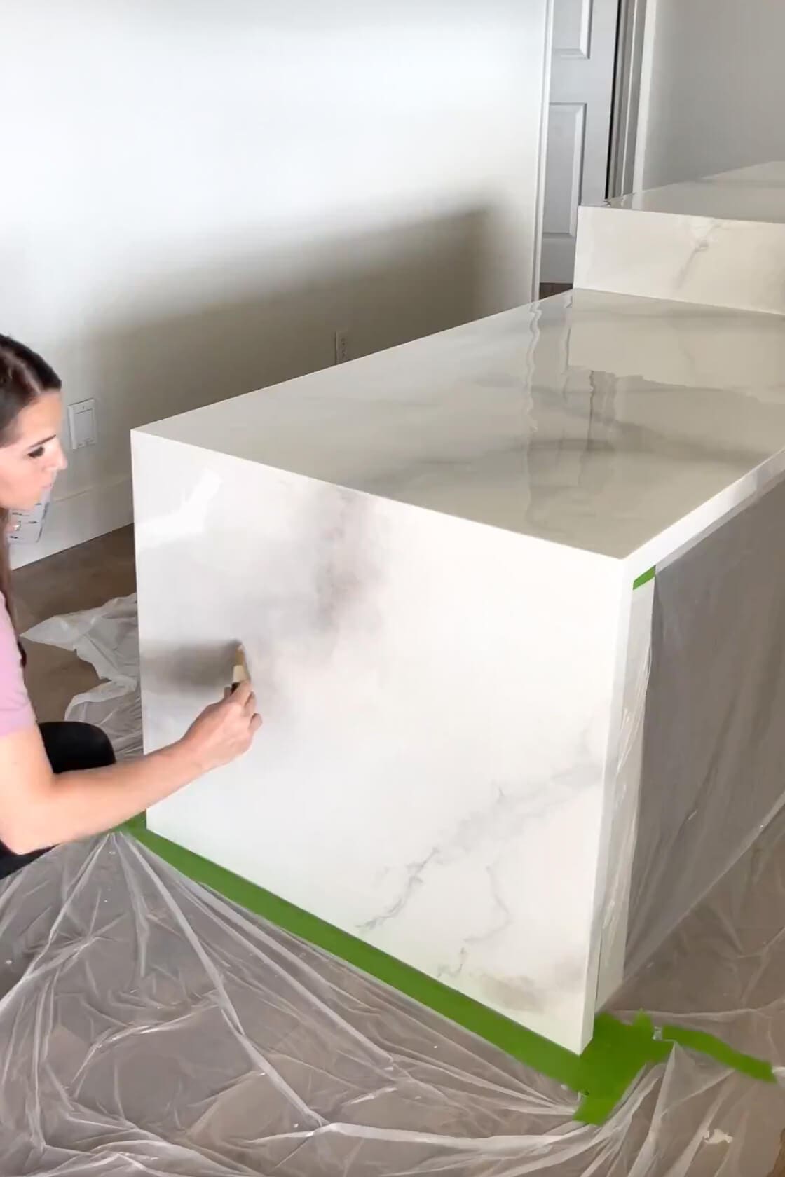 Hand-painting a marble effect on a kitchen island panel as part of a DIY epoxy countertop makeover