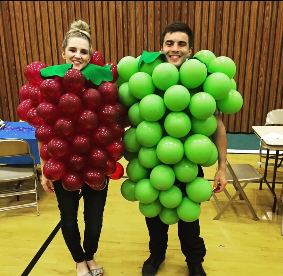 Funny couples costume idea featuring a creative grape costume made from red and green balloons with felt leaves.