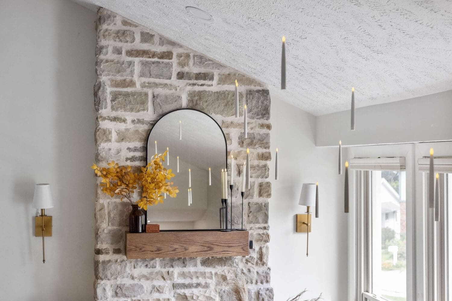 Floating candle Harry Potter decor above a stone fireplace mantel with fall accents.