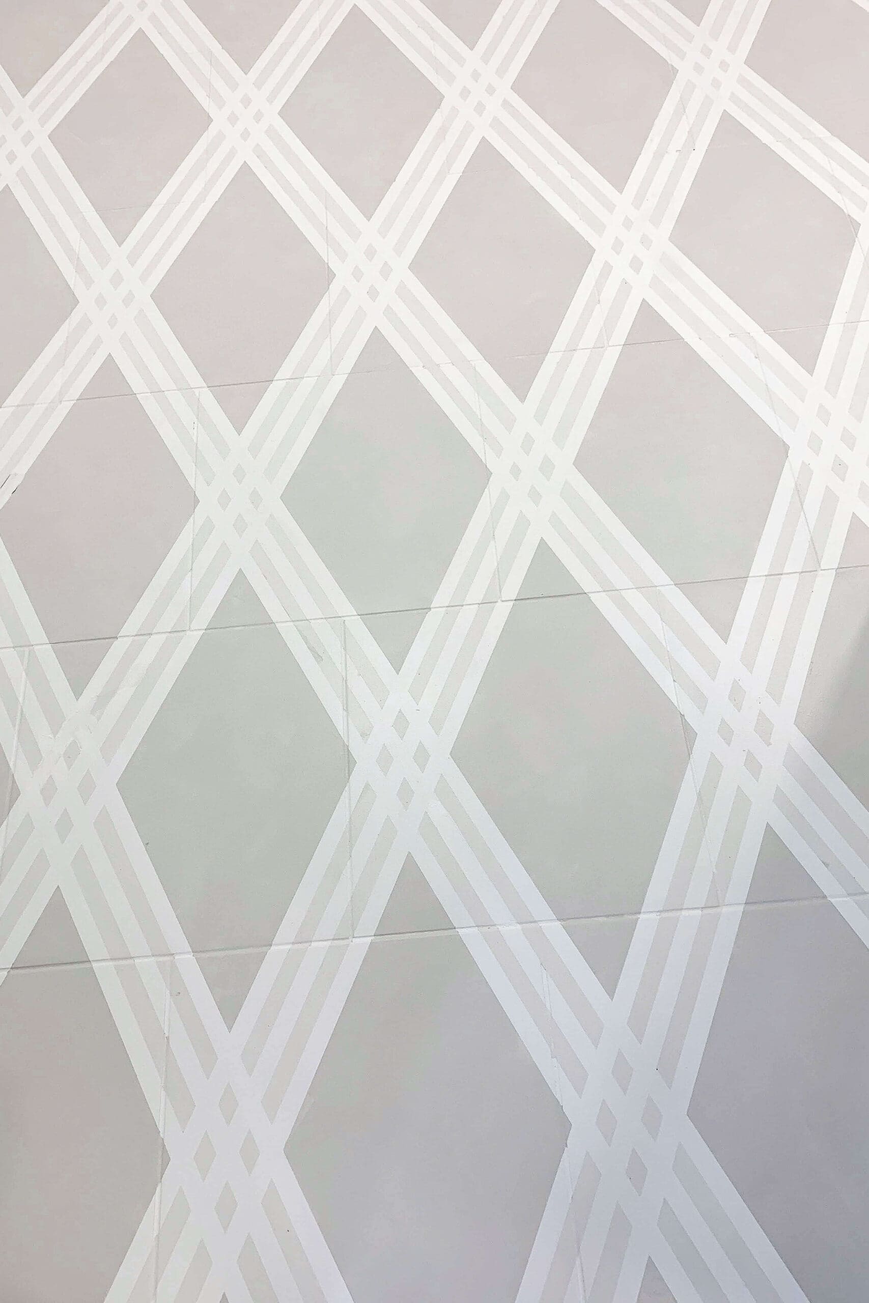 Using masking tape to create a plaid design on a laundry room floor. 