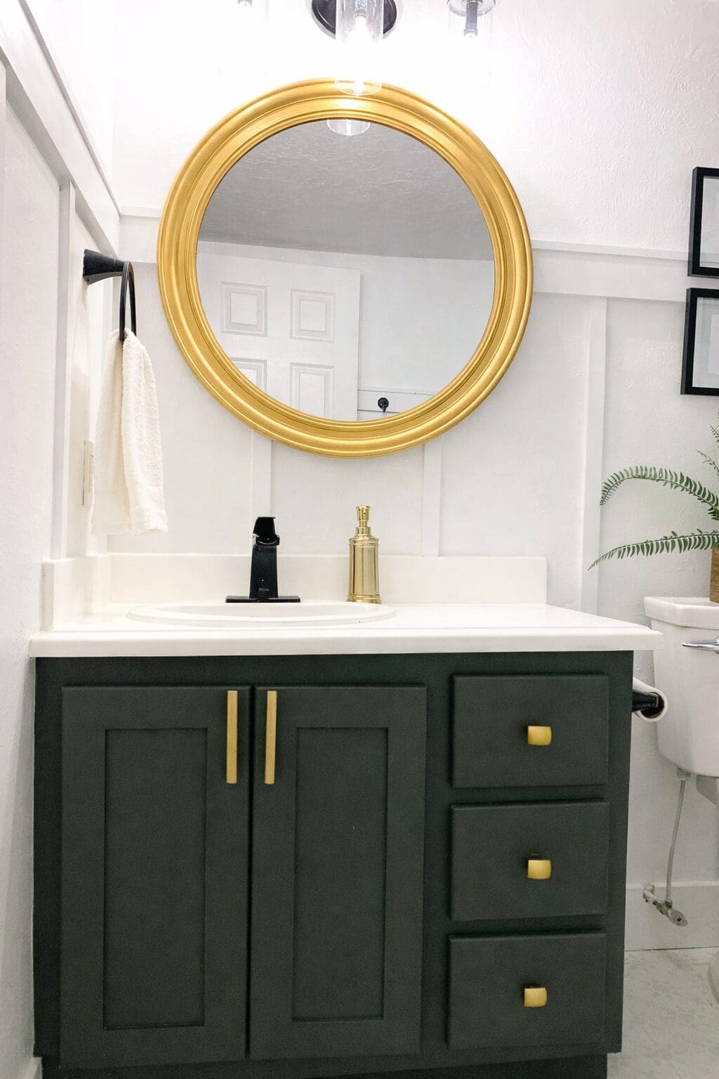Painted bathroom vanity featuring Sherwin-Williams Rock Bottom, a deep dark gray green.