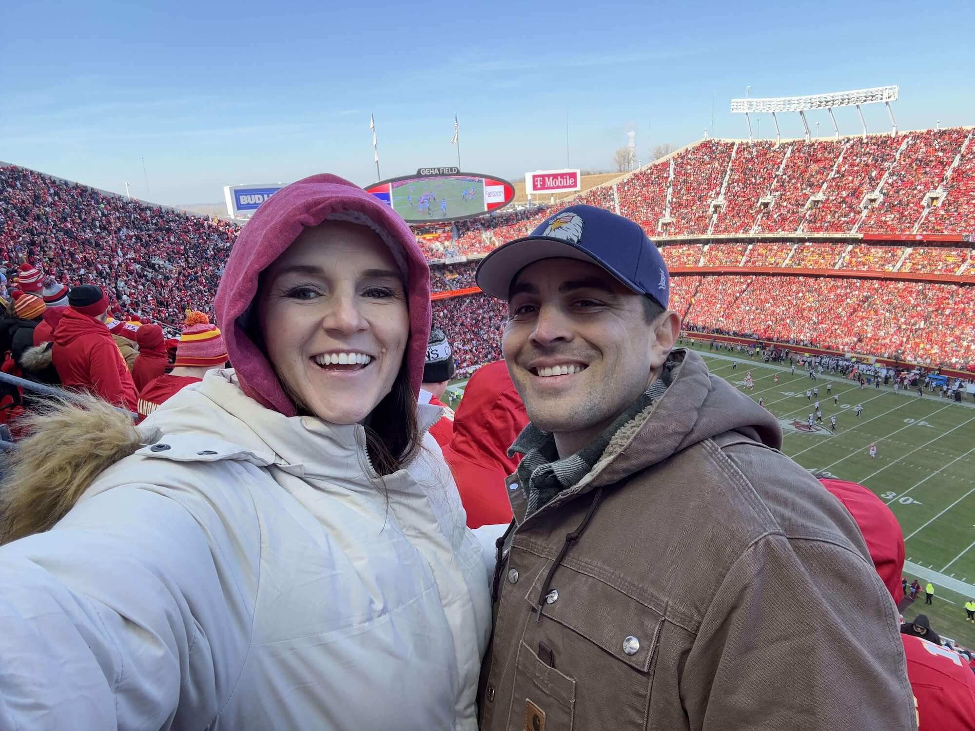 Couple enjoying a live football game, the ultimate backdrop for planning your next game day food menu.