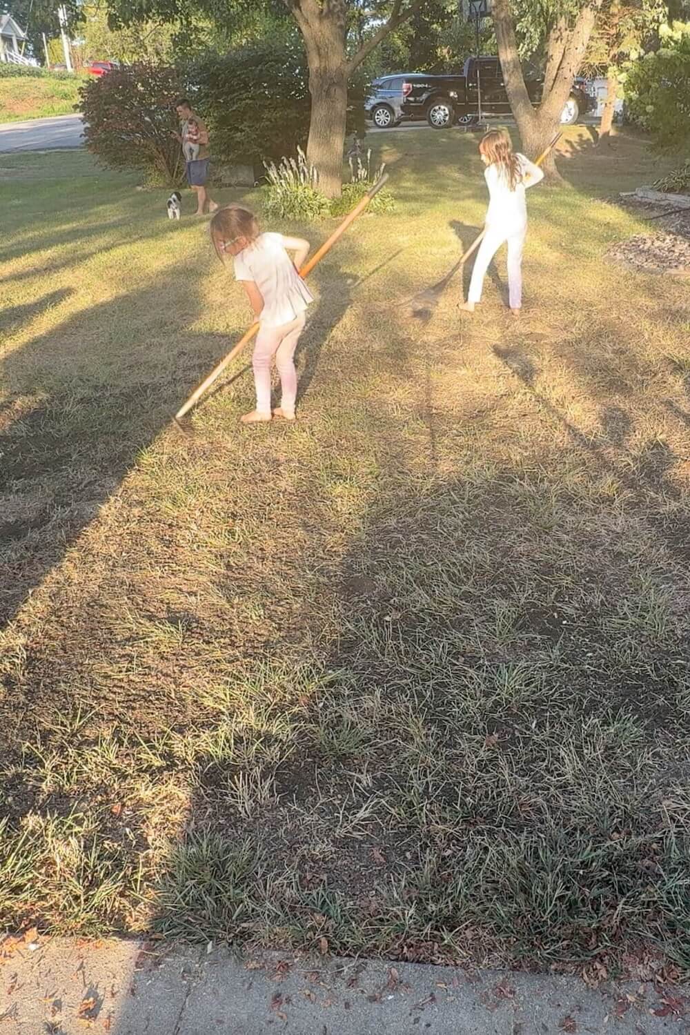 kids spreading soil evenly over yard