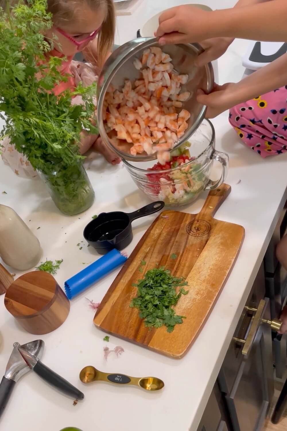 Kids prepping shrimp ceviche — a fresh and surprising addition to your list of football game day food ideas.