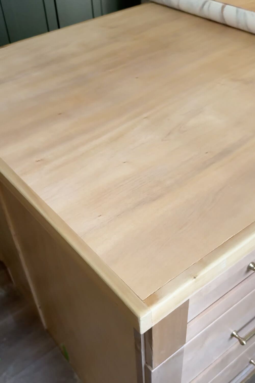 Plywood kitchen island countertop sanded, sealed, and ready for marble contact paper application in a DIY faux marble counter project.