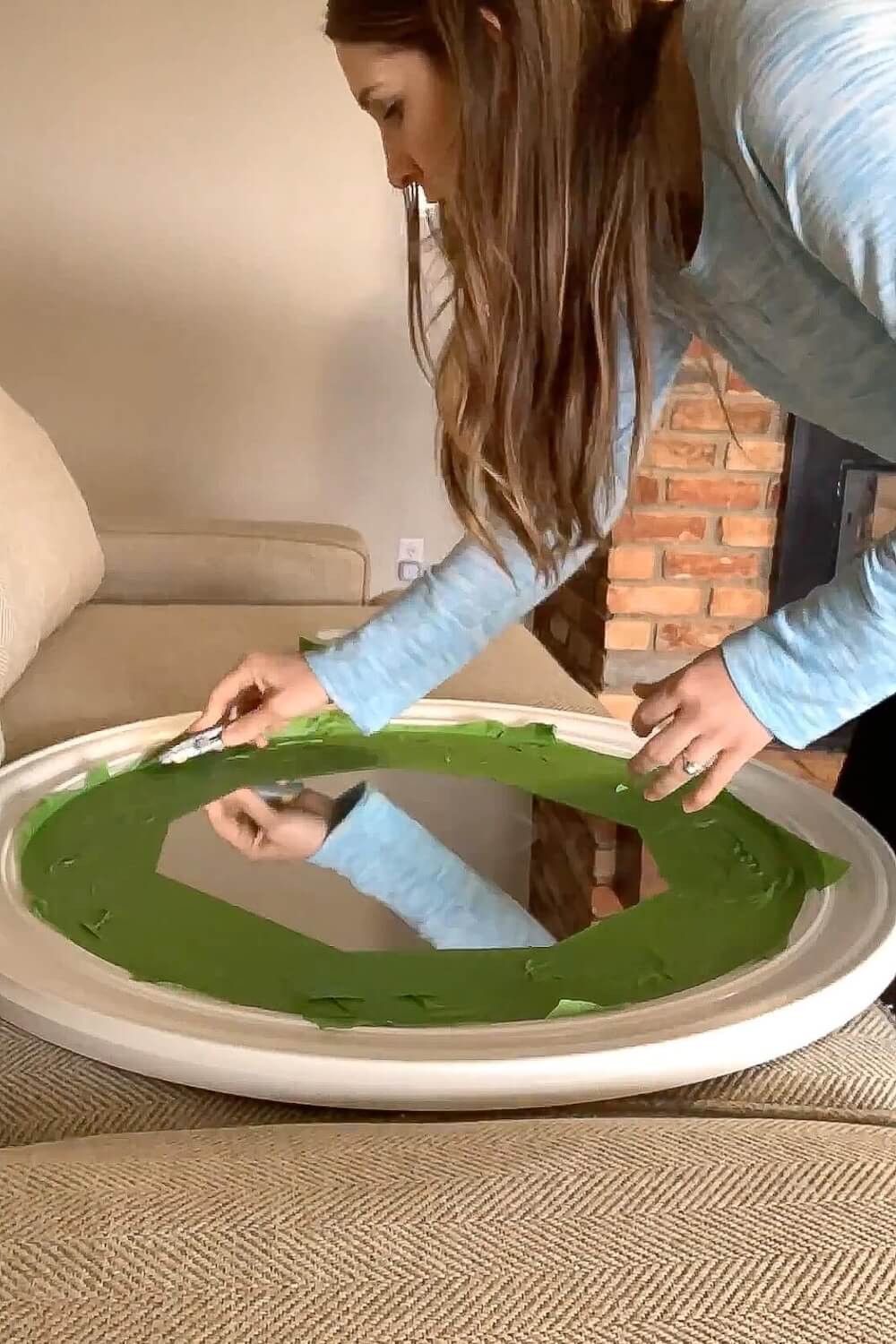 Painter’s tape covering mirror glass before painting the frame