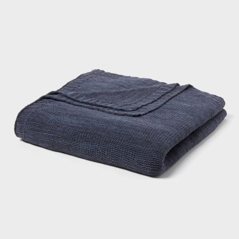 blue knit blanket folded, textured layer for cozy fall bedding in a guest room refresh