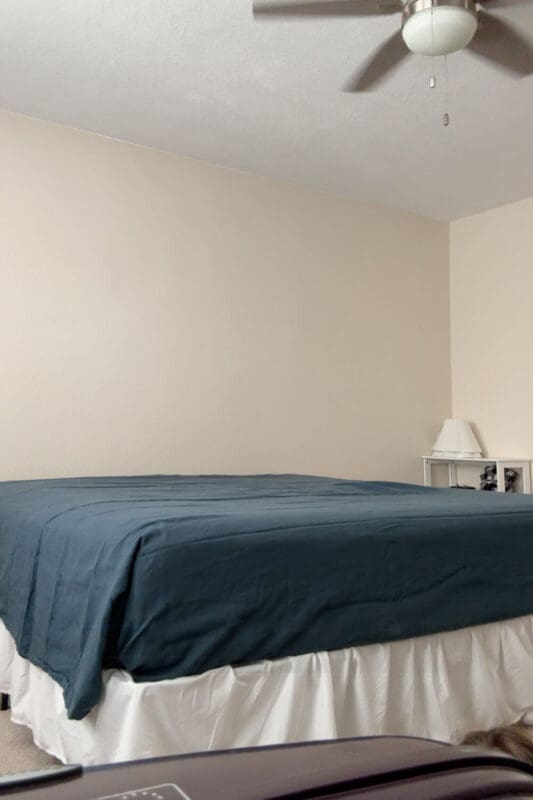 cozy fall bedding step with dark blue linen sheets smoothed over the guest bed before pillows and decor