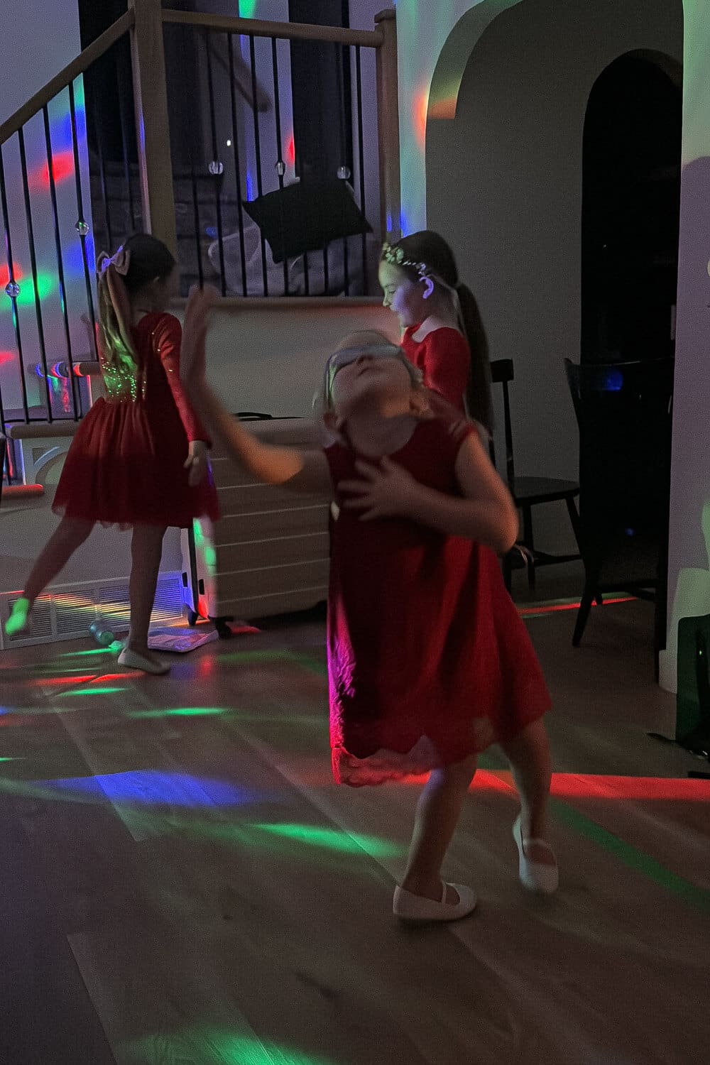 Kids dance party at home with disco lights, using our family friendly playlists by decade (1950s to 1990s).