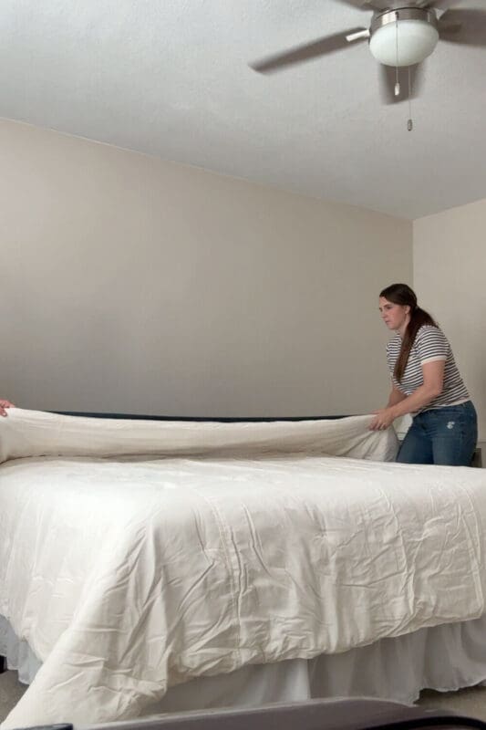 guest room refresh in progress, layering a cream duvet on the bed for cozy fall bedding