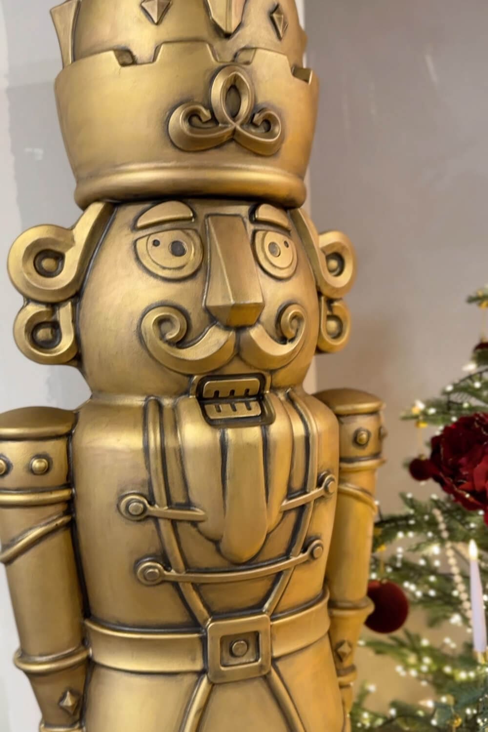 Close up of an antique bronze giant nutcracker showing the black patina detail in the grooves and trim to mimic aged metal.