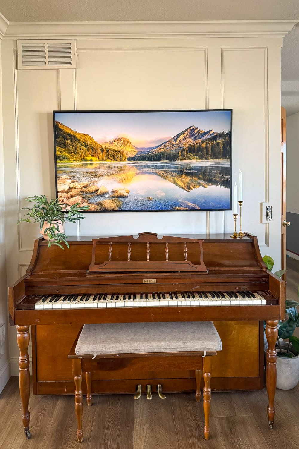 Living room reveal with DIY box molding wall trim painted Sherwin-Williams Accessible Beige, featuring a Frame TV mounted above an upright piano.