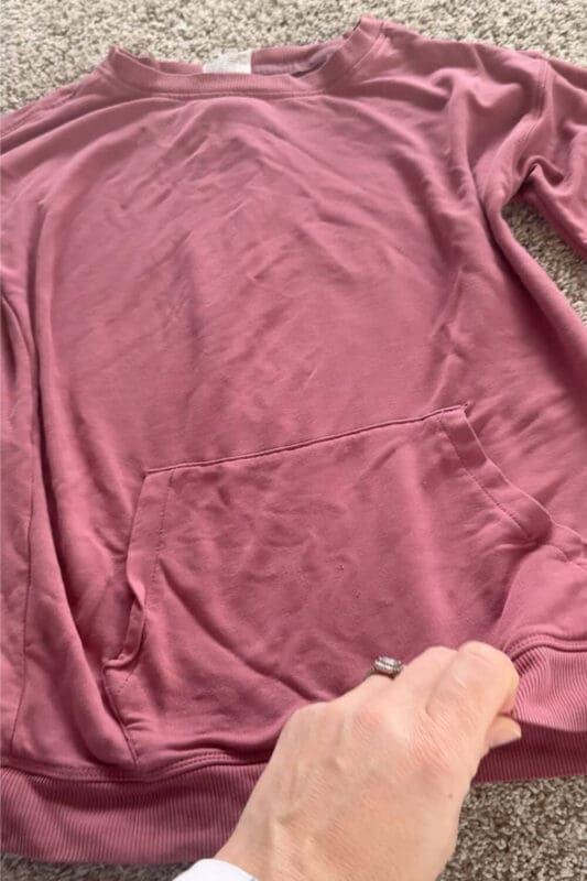 Kids sweatshirt after laundry stripping, looking cleaner and brighter with the gross detergent buildup and grime removed from the fabric.