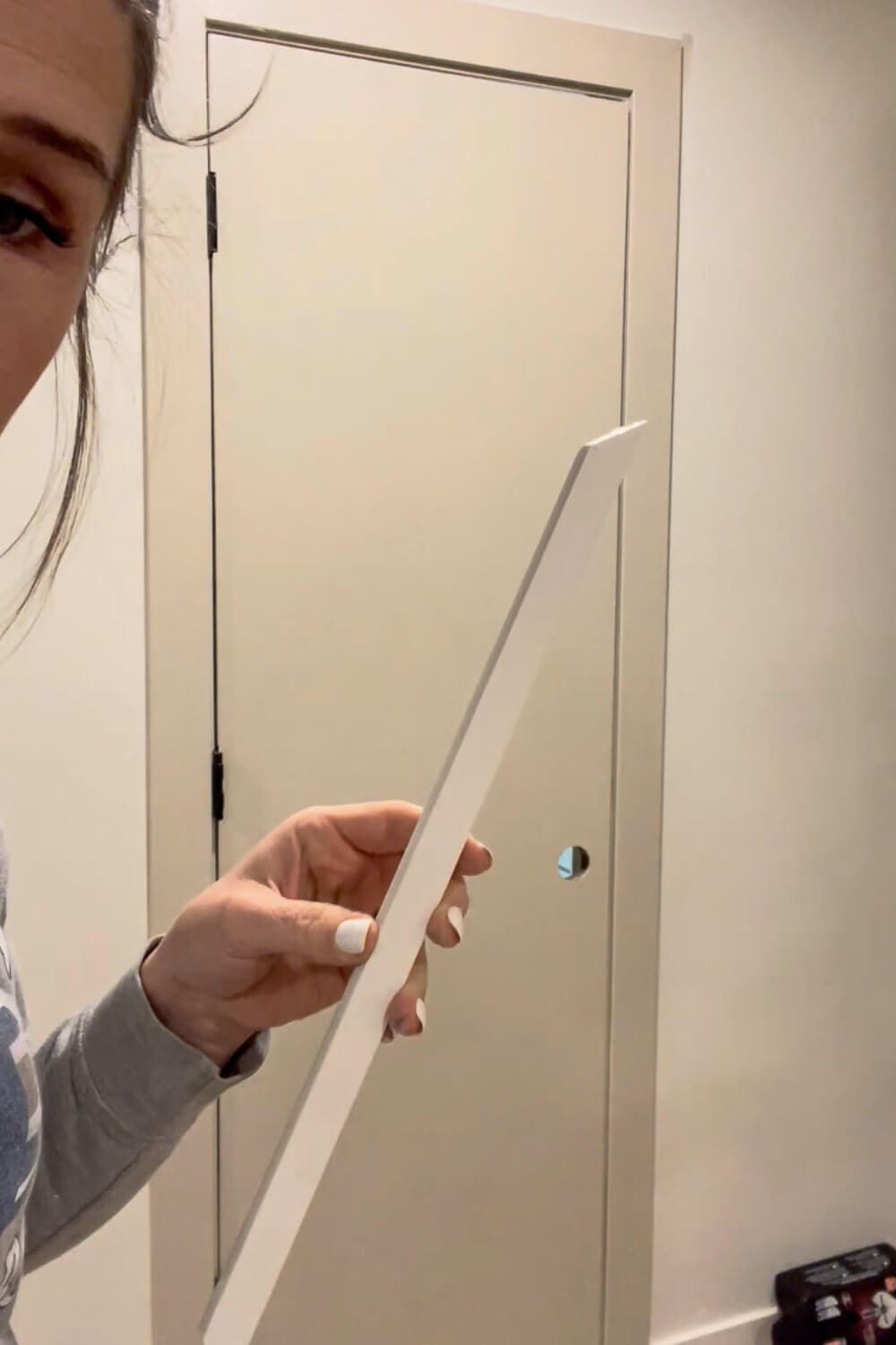 Mitered trim piece cut to size for DIY interior door upgrade