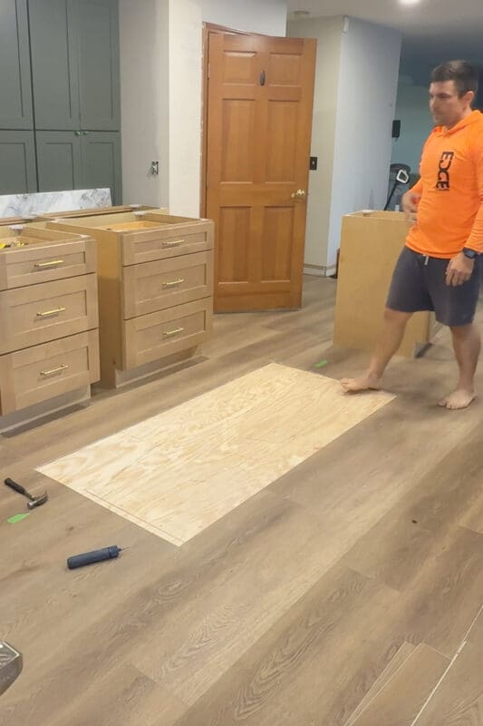 Removing flooring to to make way for a kitchen island to be installed directly to the subfloor.