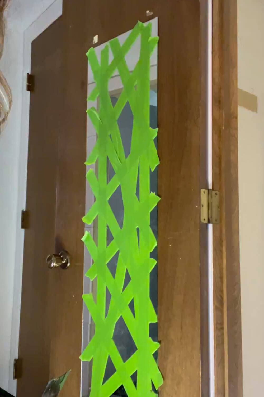 Taping door mirror with green tape before removal for DIY door upgrade