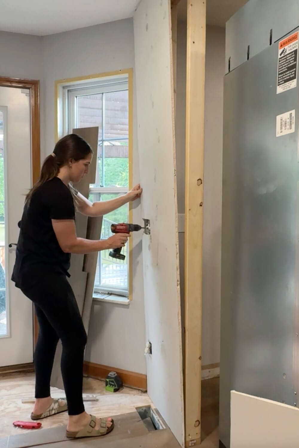 Installing drywall on the new fridge surround wall so our panel-ready counter-depth refrigerator looks built-in.