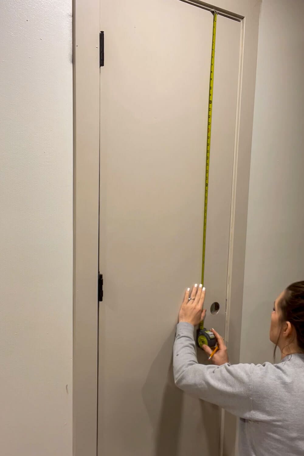  Measuring interior door height for trim placement in DIY upgrade
