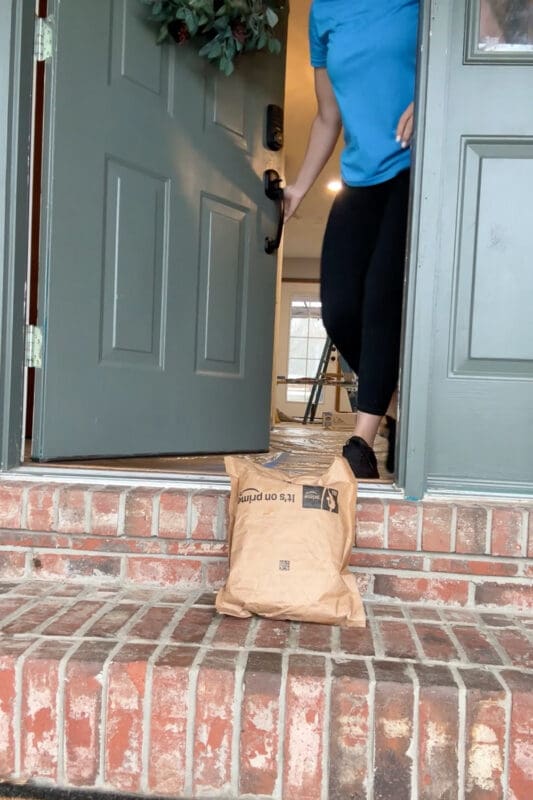 Amazon package delivered on front porch with genie lamp inside used to surprise kids with a Disney trip