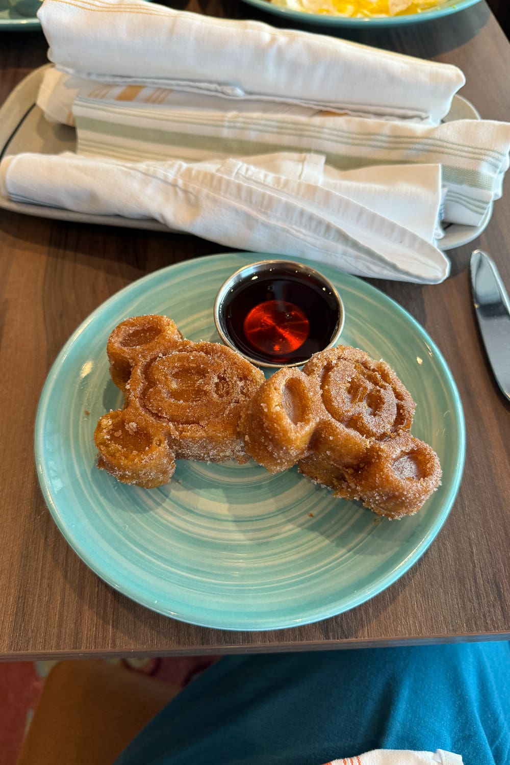 mickey shaped waffles with syrup served on disney cruise breakfast plate showing fun kid friendly food onboard