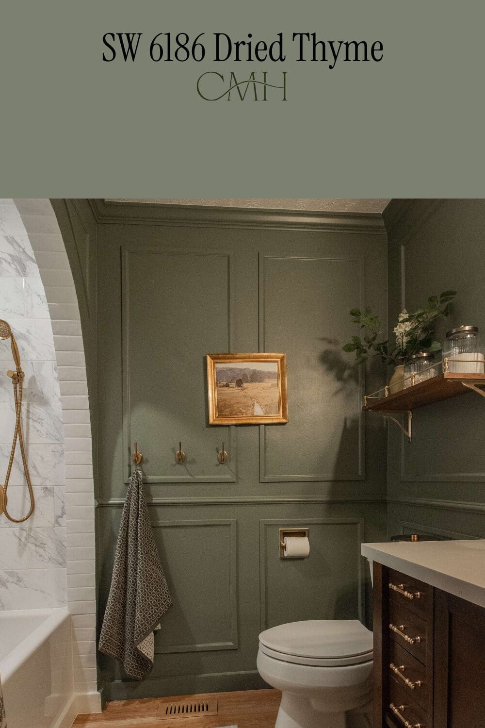 SW 6186 Dried Thyme paint color on guest bathroom walls with crown moulding detail and gold fixtures