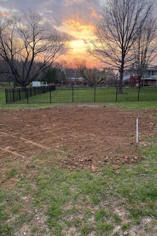 Leveled ground for garden beds after compacting soil with a plate compactor in yard