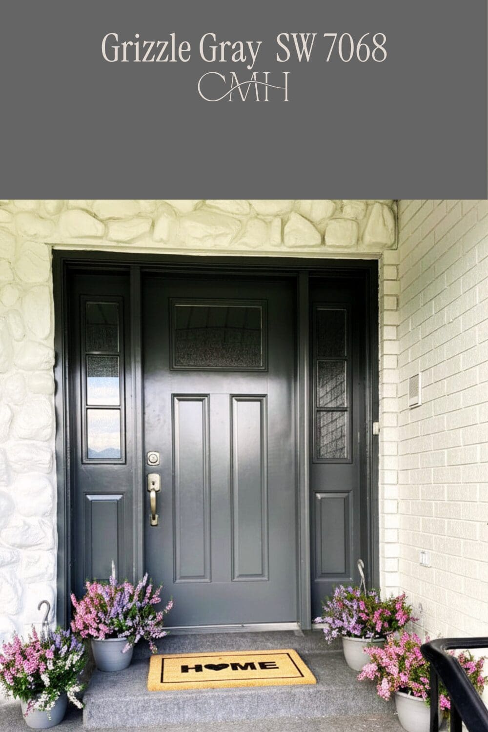 SW 7068 Grizzle Gray on front door with white painted stone and brick exterior and purple floral porch decor