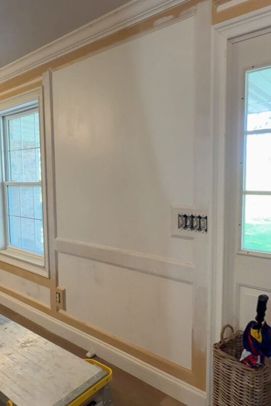 Entryway wall before decorating, showing freshly installed board and batten wall trim ready for paint and gallery wall styling