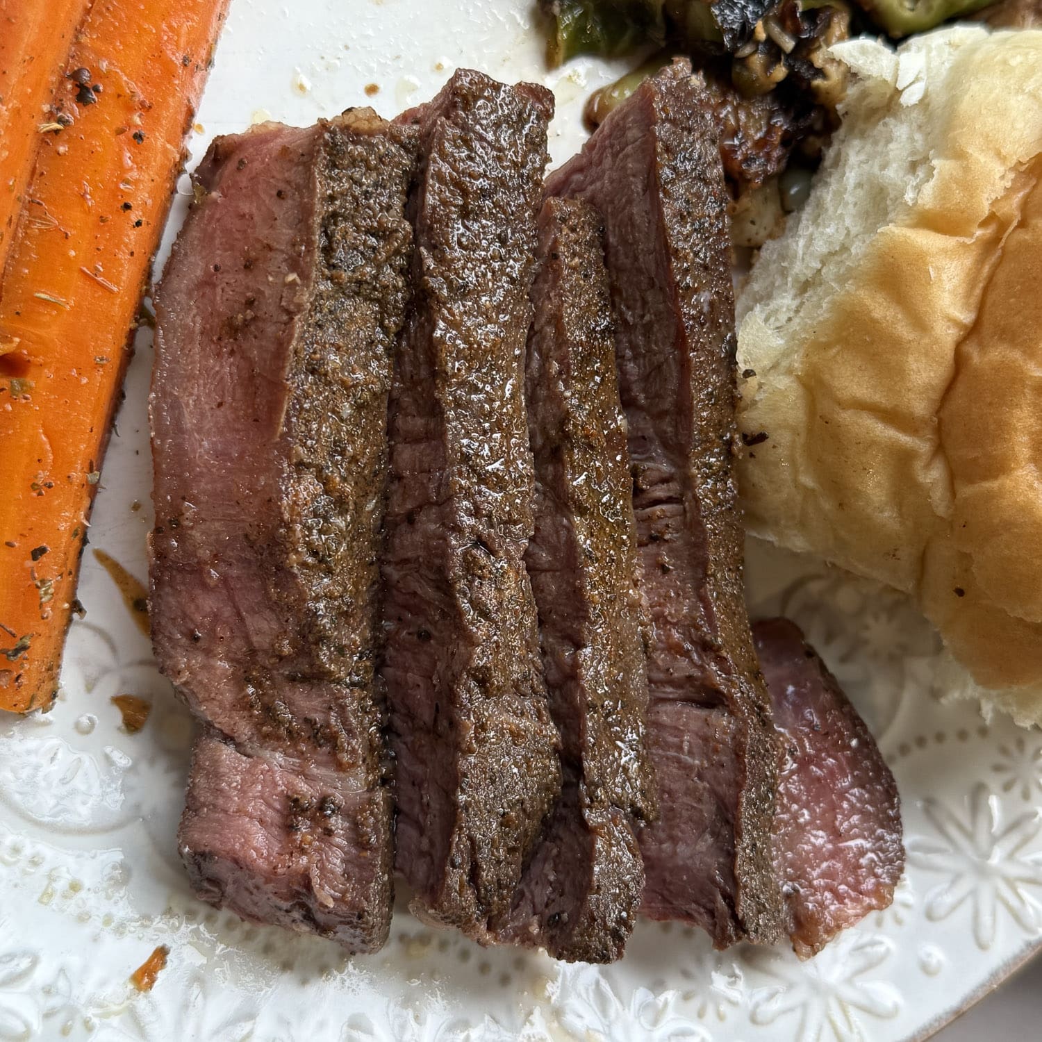 Close-up of sous vide steak slices showing a tender pink center and seasoned seared crust