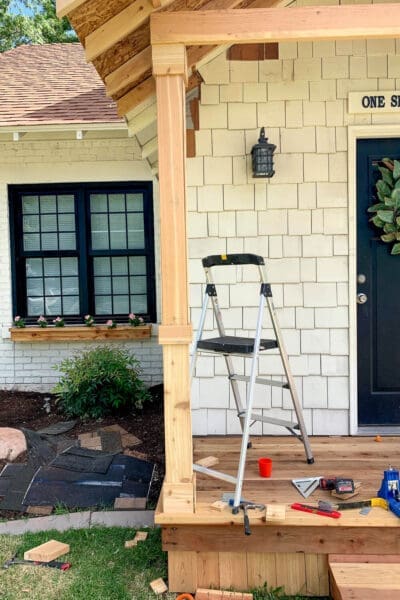 Cedar-wrapped porch columns under the new porch roof framing