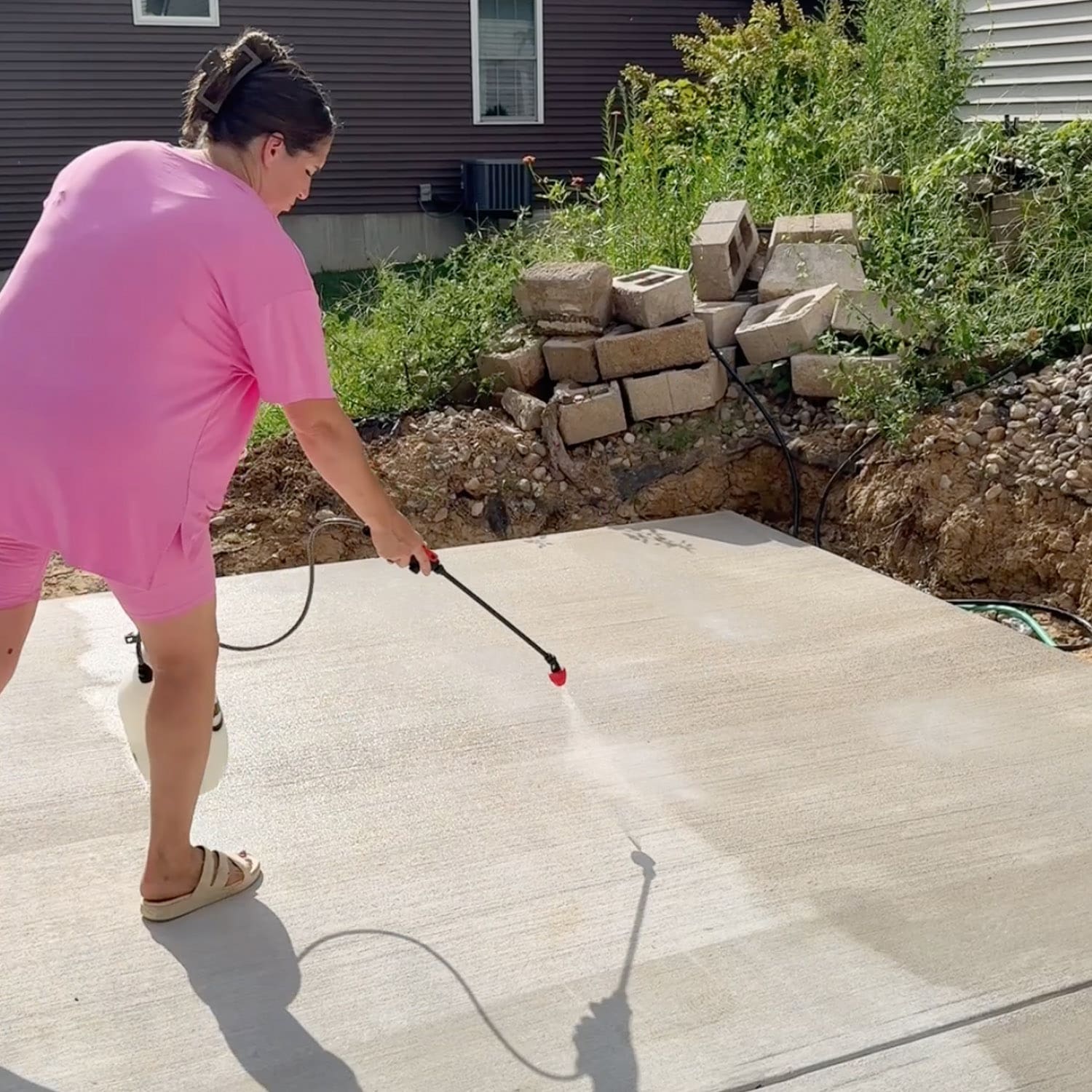 Concrete patio sealing in progress as Crystel works her way across the new slab