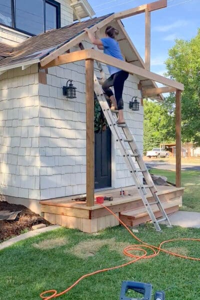 Installing initial fascia boards along roof slope for DIY porch roof project