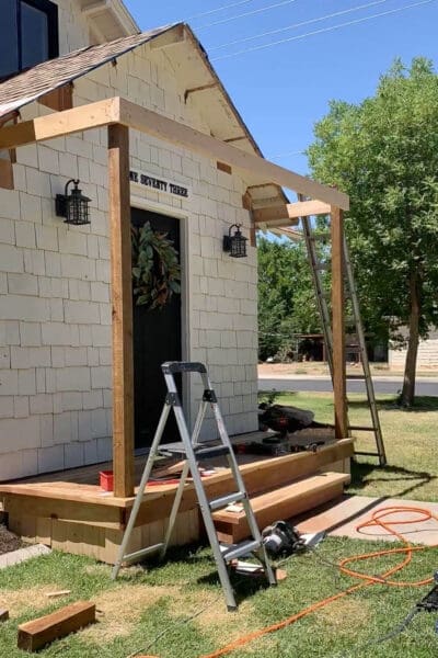 Flat frame for a porch roof attached to the house with posts and header in place