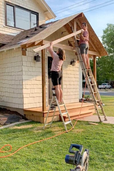 Screwing down OSB panels during porch roof installation