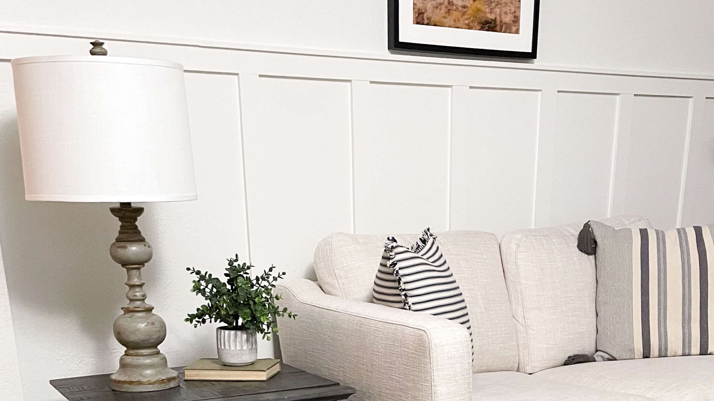 Cozy living room showcasing a simple DIY accent wall with vertical battens, paired with a farmhouse-style side table and neutral decor.